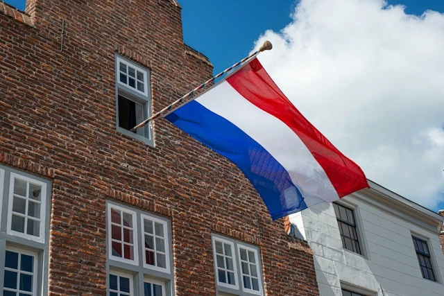 Building with a Dutch flag displayed on the exterior, used to illustrate information about the Consulate General of the Netherlands in Bengaluru.